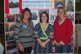 Gill, Naomi Kennedy Faith, and Ruth standing in a line in front of an information board.
